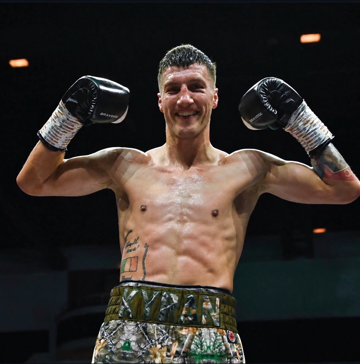 Kyran Jones celebrating in the boxing ring with both gloves raised