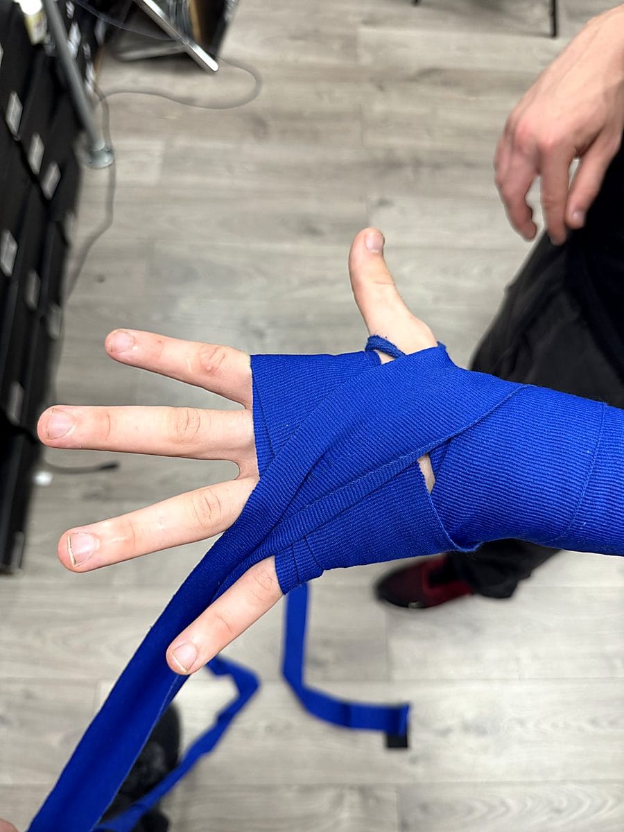 Step 4: Wrap between the fingers to separate and support each metacarpal